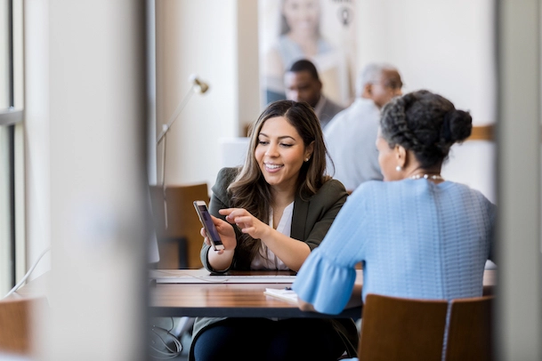 Image of two coworkers talking